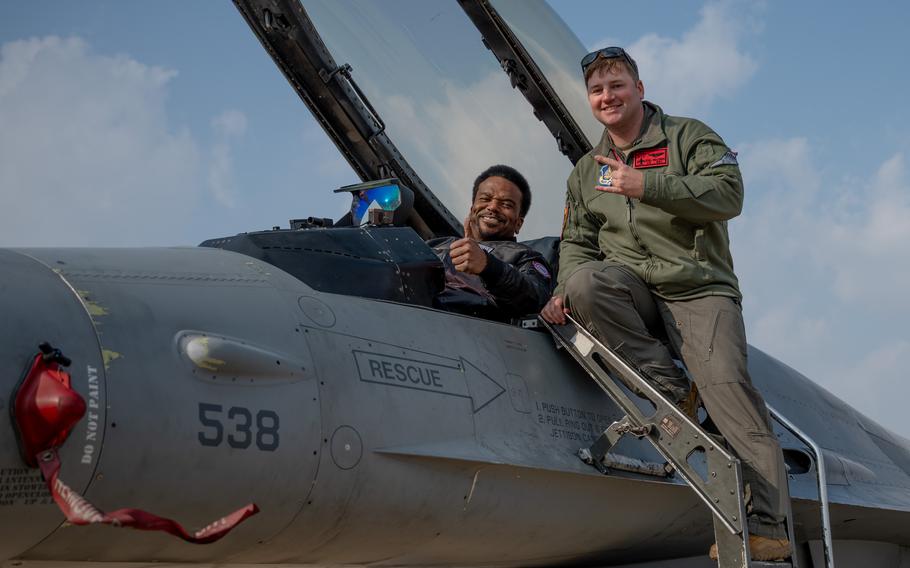 Robinson flashes a thumb’s up from the cockpit.